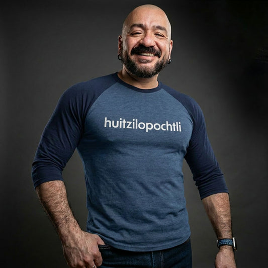 Huitzilopochtli 3/4 baseball tee: blue body, navy blue raglan sleeves, name printed in white across the chest.