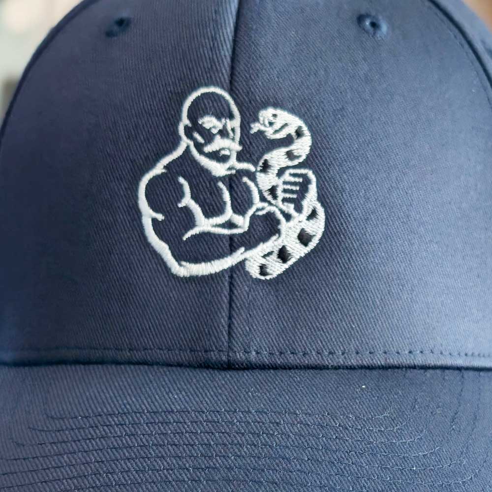 The Snake Hierophant Baseball Hat – Fitted Curved-Brim Cap with Mustached Bodybuilder and Snake Embroidery