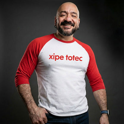 Xipe Totec 3/4 baseball tee: white body, red raglan sleeves, name printed in red across the chest.