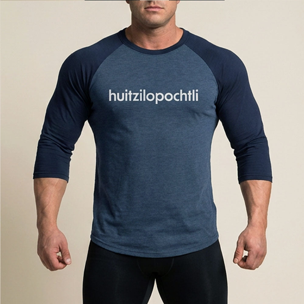 Huitzilopochtli 3/4 baseball tee: blue body, navy blue raglan sleeves, name printed in white across the chest.