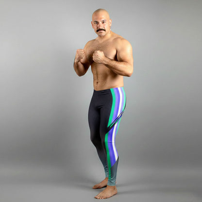 Male bodybuilder in MLM Pride flag colors bodybuilding tights with quetzal emerald green accents.