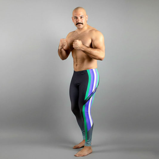 Male bodybuilder in MLM Pride flag colors bodybuilding tights with quetzal emerald green accents.