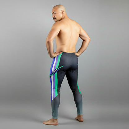 Male bodybuilder in MLM Pride flag colors bodybuilding tights with quetzal emerald green accents.