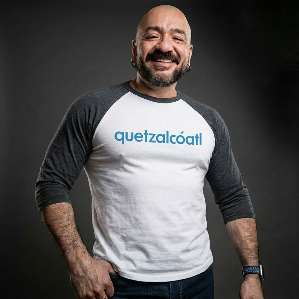 Quetzalcóatl 3/4 baseball tee: white body, charcoal raglan sleeves, name printed in blue across the chest.