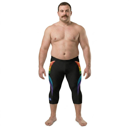 Man wearing blackcapri tights with rainbow design on a white background